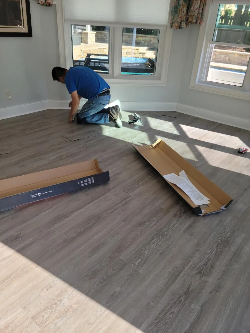 Laminate flooring being installed in well lit room