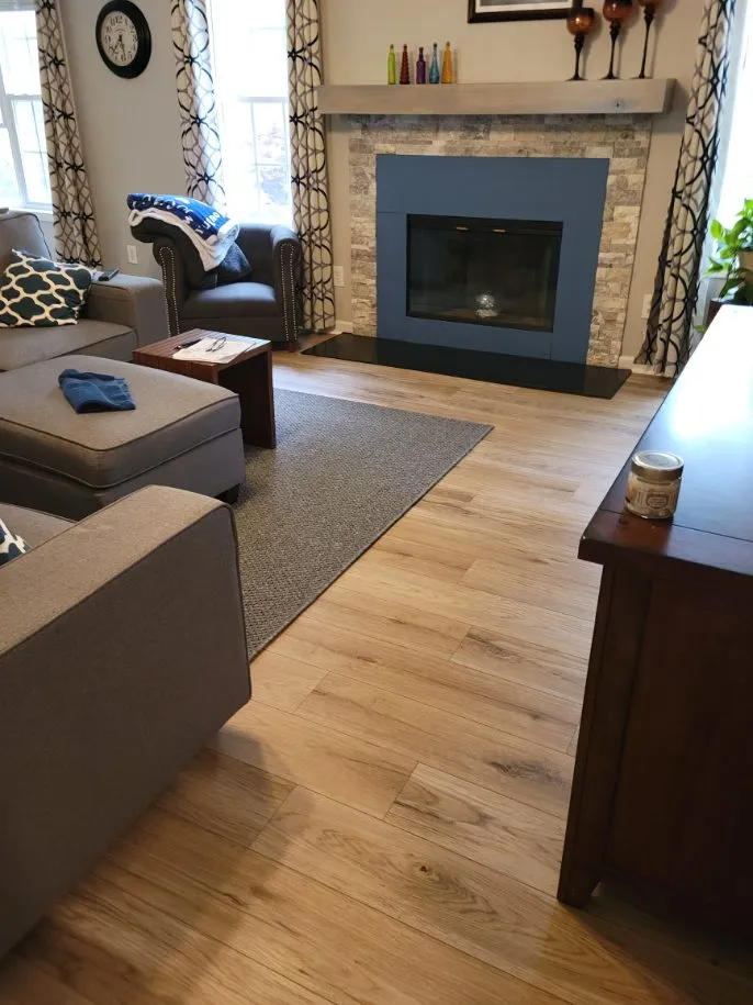 New hardwood floor in living room with fireplace